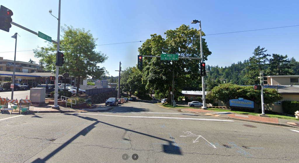 A photo of an intersection with traffic lights. 