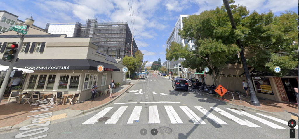 A view of a pedestrian crossing on a commercial street. 