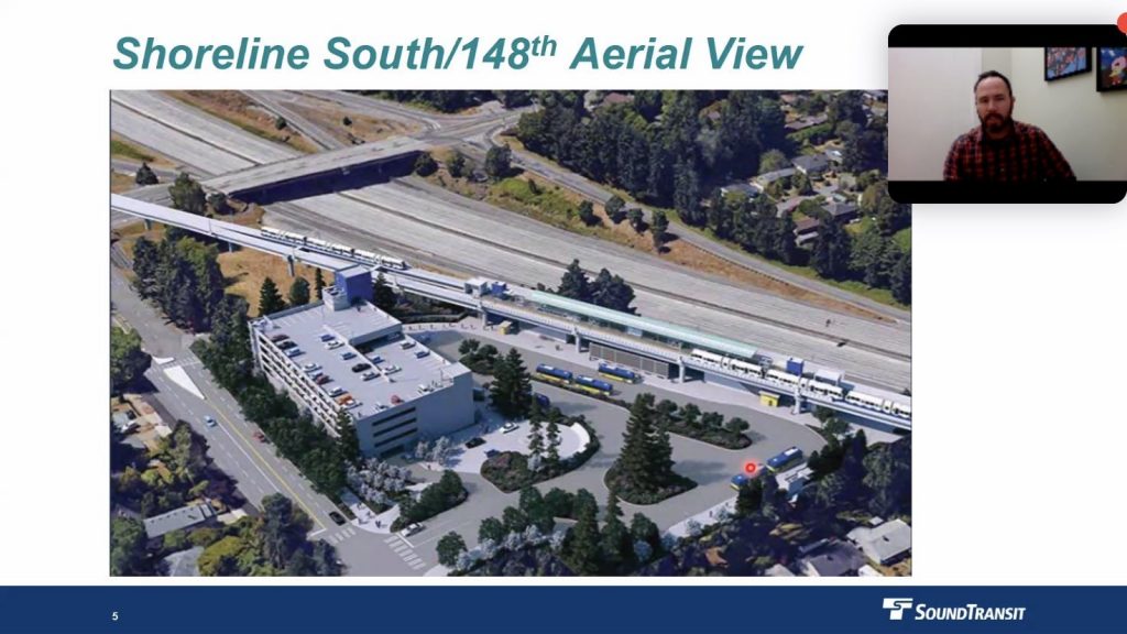 A screenshot from a Zoom presentation on development at the 148th Street light rail station shows an aerial view of the station area and a small box showing the presenter - a man in a red and black plaid shirt. 