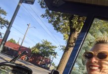 Subscriber Drive Testimonial: Anna Zivarts Anna smiles taking a selfie sitting next to her son at a bus stop shelter.