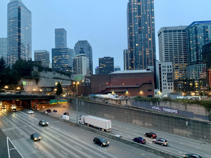 A photo shows the I-5 freeway in Downtown Seattle near the Washington State Convention Center.
