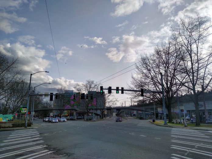 A wide intersection where two streets meet at an angle, some legs without crosswalks.