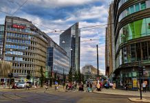 Four Years Later, Seattle Emissions-Free Area Has Gone From Promise to Draft Plan A photo of a city street without cars. There are tram lines and people walking and biking.