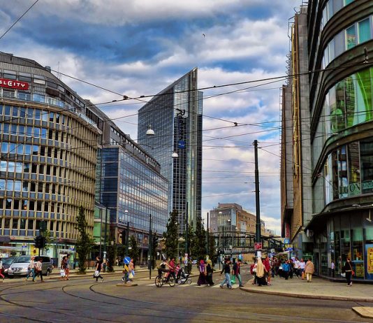 Four Years Later, Seattle Emissions-Free Area Has Gone From Promise to Draft Plan A photo of a city street without cars. There are tram lines and people walking and biking.