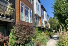 Council Renames Single-Family Zoning, Decriminalizes Magic Mushrooms, and Clears Way for Storm Practice Facility in Interbay A photo of townhouses with lush shrubs and trees.