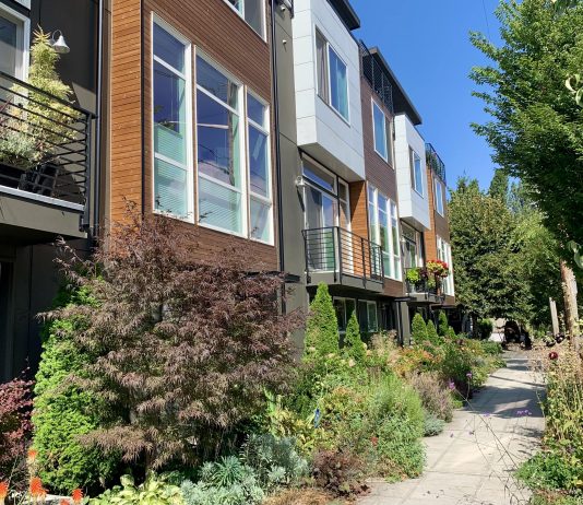 Council Renames Single-Family Zoning, Decriminalizes Magic Mushrooms, and Clears Way for Storm Practice Facility in Interbay A photo of townhouses with lush shrubs and trees.