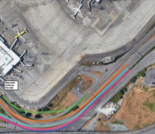 Port of Seattle Commission Taps Brakes on Arrivals Drive Expansion A photo shows an roadway leading to an airport terminal. Colors are used to identify where the roadway will be expanded.