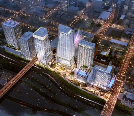 ULI’s Fall 2021 Meeting Predicts the Future of Cities Rendering of five glassy towers, viewed from above, and lit up among a darkened city.