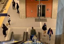 Northgate Link Light Rail Expansion: How We Arrived A photo of an illuminated escalator leading down to a light rail platform.