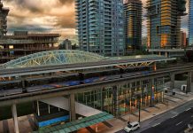 It’s Time for Seattle’s Transit Oriented Development to Grow Up A photo of a light rail station surrounded by tall modern buildings, some of which are still under construction.