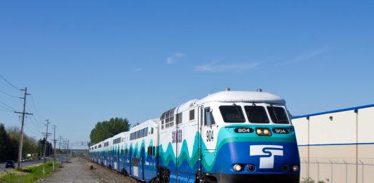A photo of a blue and white locomotive on a modern train.