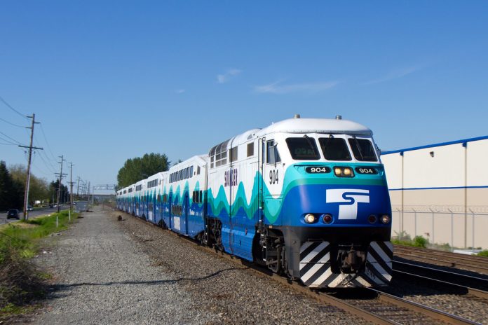 A photo of a blue and white locomotive on a modern train.