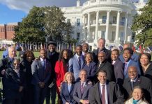 A Closer Look at Biden’s Historic Infrastructure Bill A group of people in business attire pose in from the White House.