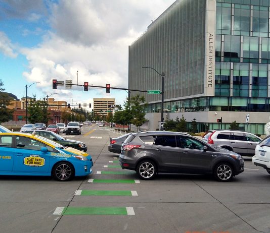 Seattle To Roll Out First Block-the-Box Camera Enforcement and Expand Transit Lane Cameras in 2022 A photo showing cars blocking a marked intersection for pedestrians.