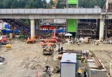 Lynnwood Link Light Rail Extension Officially 50% Complete A photo of an active construction site with trailers in front of a light rail line.