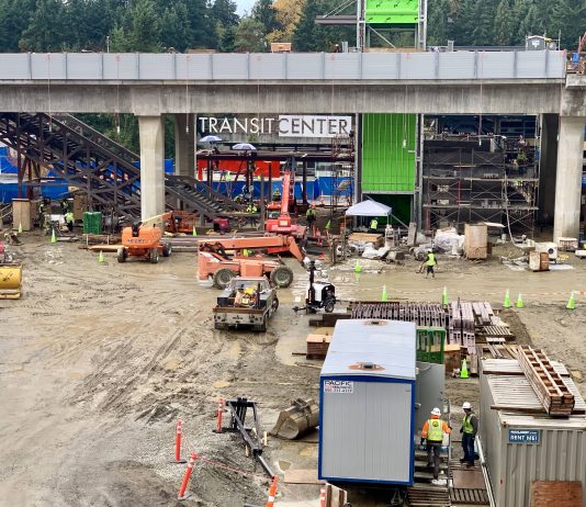 Lynnwood Link Light Rail Extension Officially 50% Complete A photo of an active construction site with trailers in front of a light rail line.