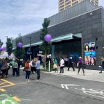 People gather on the street in the U district