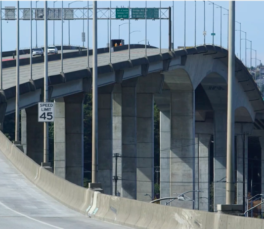 West Seattle High-Rise Bridge on Track to Reopen Mid 2022 A photo of a high bridge made of a concrete with a roadway.