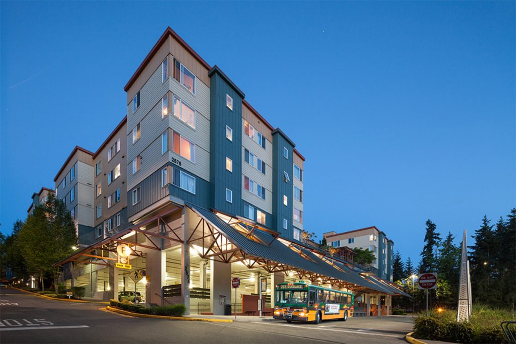 A photo showing apartment housing constructed on top of a transit center. 