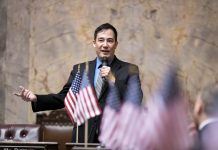Inslee Taps Hobbs as Secretary of State, Ending His Reign as Senate Transportation Chair Steve Hobbs on the senate floor with American flags in the foreground.