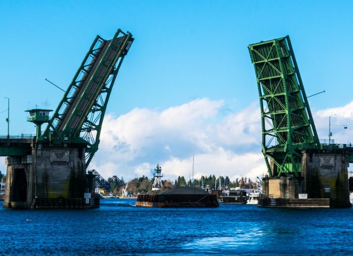 Ballard Bridge in a up position to allow a gravel filled barge to go by.