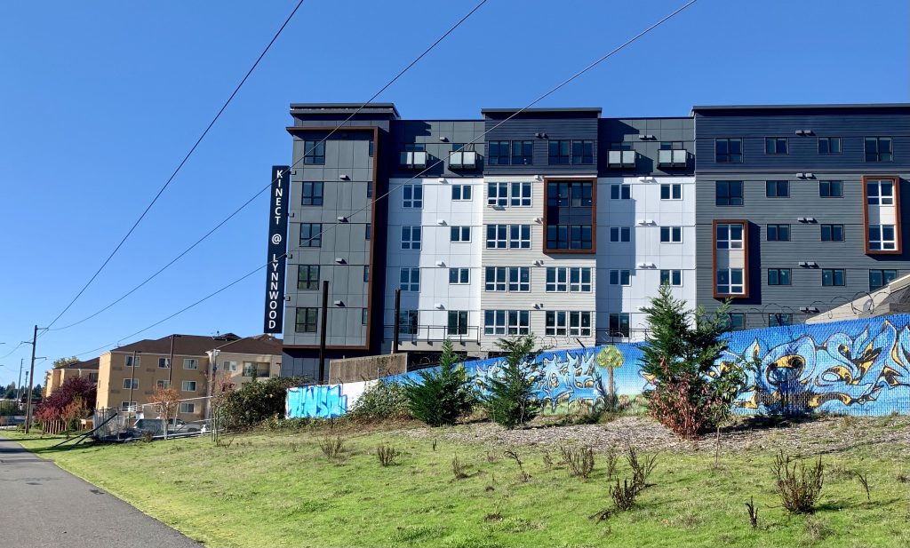 A six storey building along a road without a sidewalk