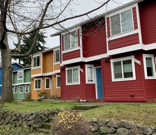 What to Know About Washington State’s Competing Missing Middle Housing Bills A photo of colorful townhouses with a tree in front.