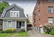 Voter Turnout Maps Tell Tale of Two Cities: Urban and Suburban A photo of a single family dwelling and an apartment building separated by an alley.