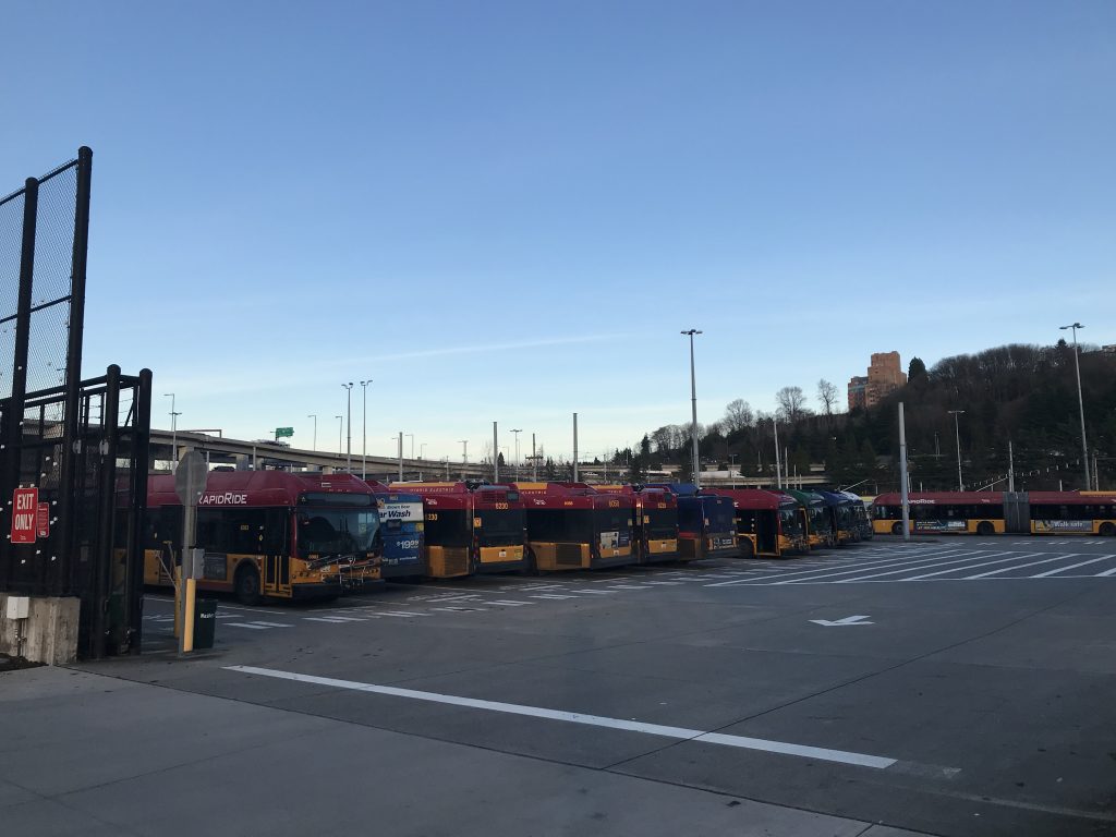 A photo of buses in a bay. 