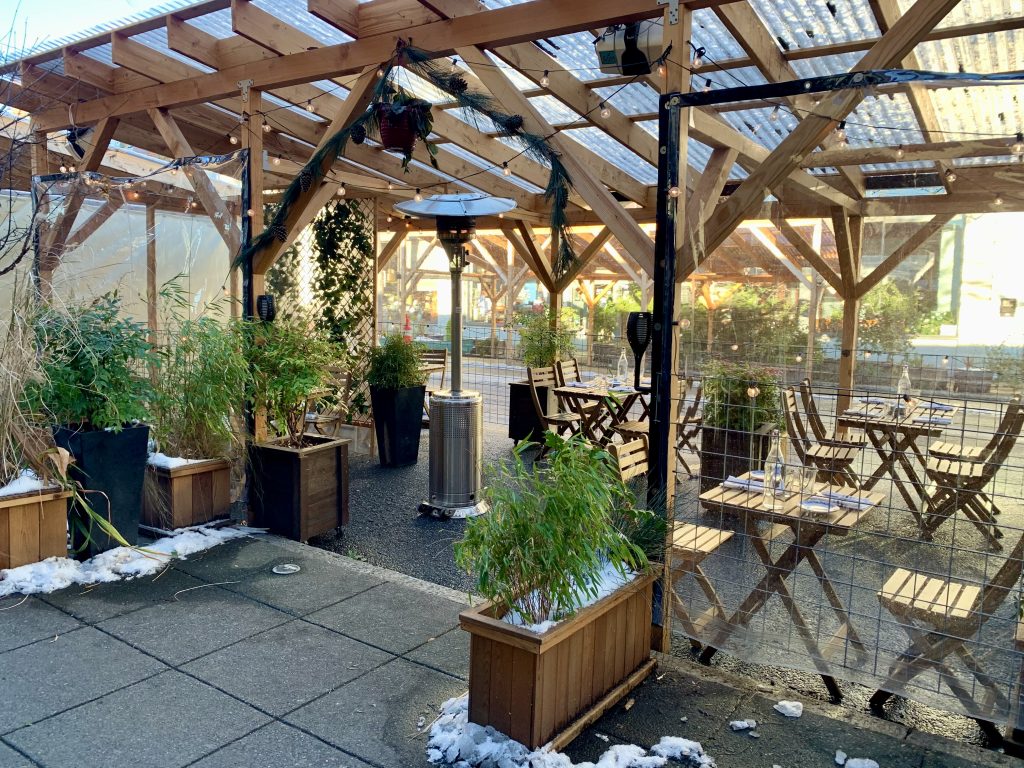 A photo of an outdoor dining area with her lamps.