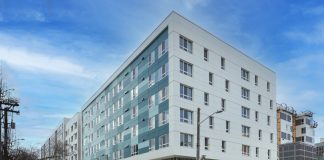 Call to Action: Speak Up For Housing Benefit Districts A photo of a white apartment building in an urban area.