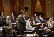 Transpo Notes: No Extra Gas Tax, Metro Staffing Challenges, Governor Makes High Speed Rail Ask A photo of a man wearing a suit in a senate chamber standing and speaking while other people in suits sit and listen.