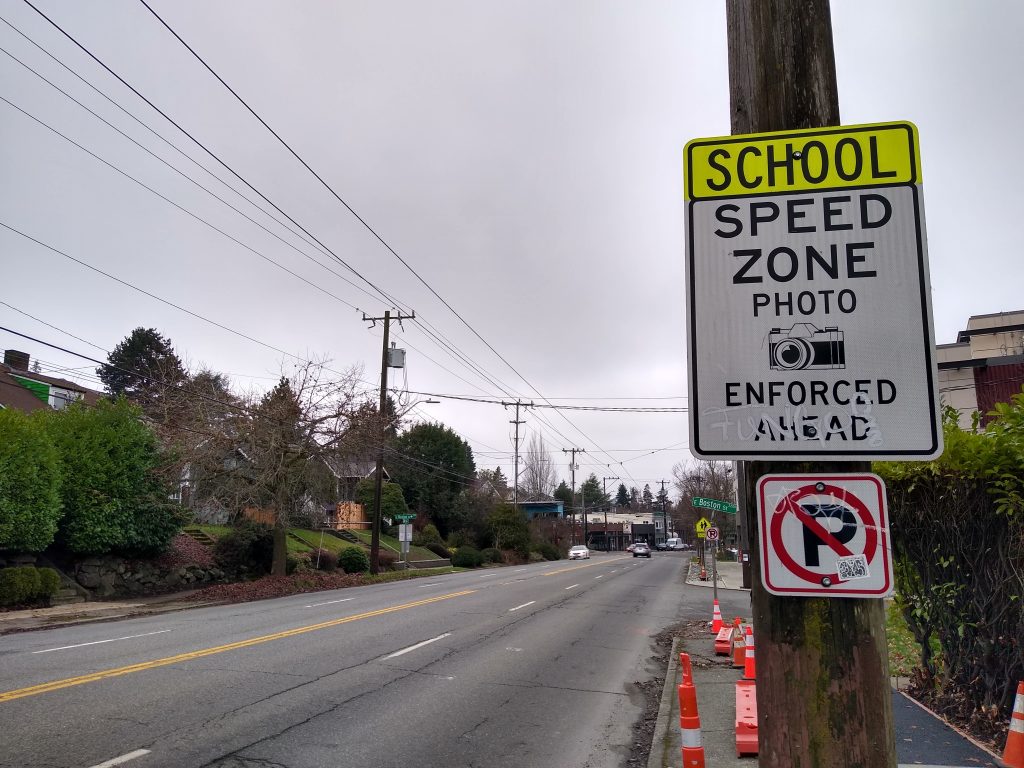 A sign reading School Zone Photo Enforced ahead
