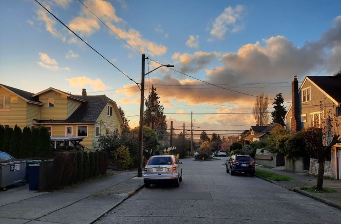 The sunsets over Salmon Bay and trickles through clouds.