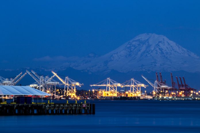 A photo of the Port of Seattle with Mount Rainier in the background.