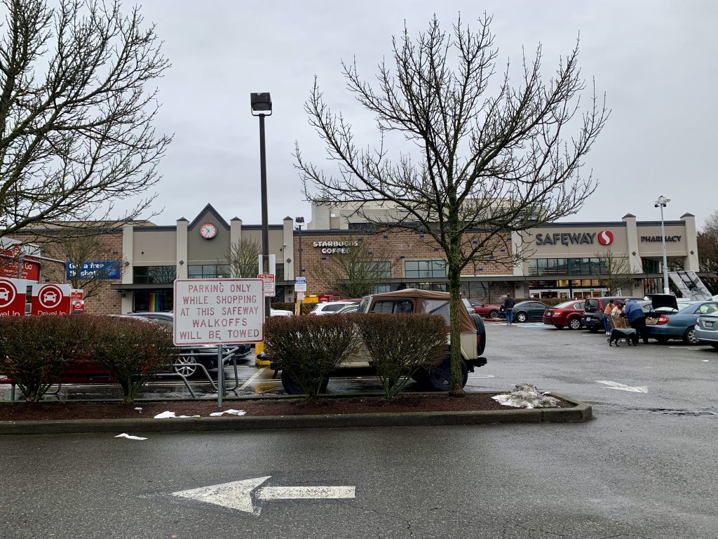 A photo of a surface parking lot in front of a grocery store.