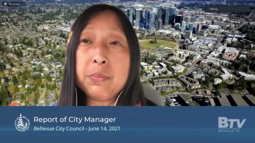 A screen shot of a woman with long dark hair and with the text report of the city manager, Bellevue city council june 14, 2021, below