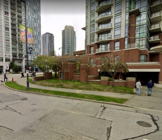 What We’re Reading: Zoning For Housing, Surrey Beats Vancouver, and Safer Cars A photo of a street with condo towers of different heights.