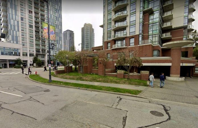 A photo of a street with condo towers of different heights.