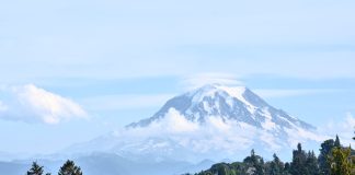 A view of a mountain in the distance behind a suburban neighborhood
