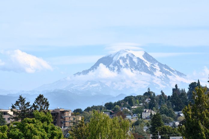 A view of a mountain in the distance behind a suburban neighborhood