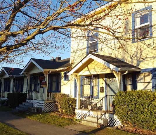 Poll Indicates Washingtonians Strongly Favor Statewide Missing Middle Housing Bill a photo of a small apartment building next to cottages