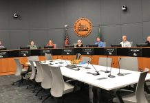 Bill to Sunset Community Councils Holds Big Stakes for Kirkland and Bellevue A photo of people sitting in a city council chamber.