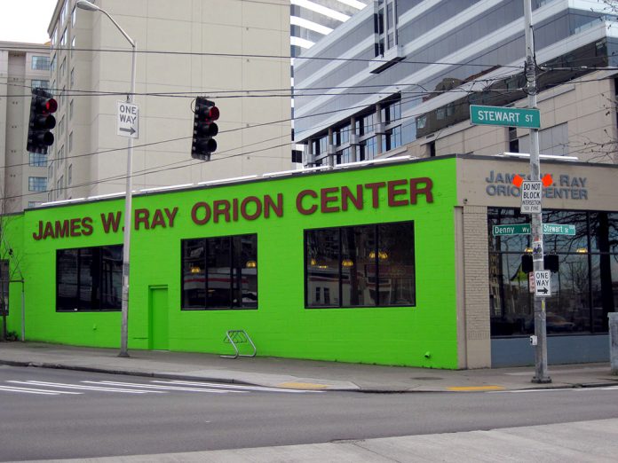 A photo of a bright green building with the words James W Ray Orion Center written on it.