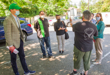 Invest in Mental Health First Responders, Not New Police Hires A photo of people standing in a circle in a parking lot
