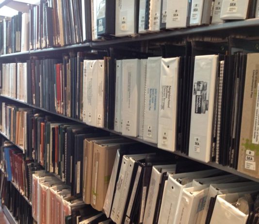 Neighborhood Plans are High Minded Gatekeeping A photo of books on a library shelves.