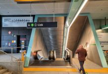 Ballard and West Seattle Light Rail Tunnel Options May Not Require Third-Party Funding A man walks toward the escalator down to the station platform.
