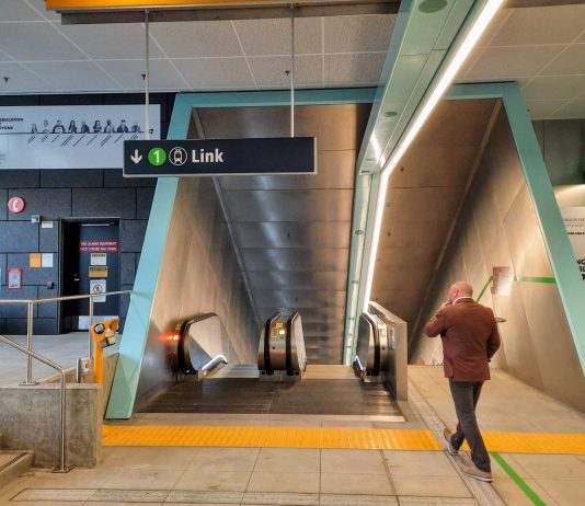 Ballard and West Seattle Light Rail Tunnel Options May Not Require Third-Party Funding A man walks toward the escalator down to the station platform.