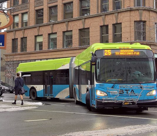Welcome to the Move Ahead Washington Era An articulated Route 25 bus in Spokane makes a turn on a downtown street after yielding to a passing pedestrian.