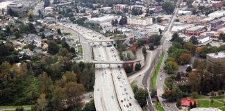 The Urbanist Podcast: How the Cold War Suburbanized America A photo of a wide highway in a suburban landscape.